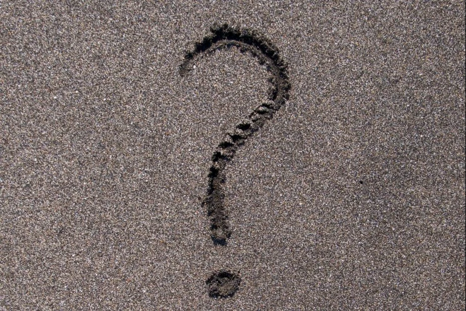 Question mark carved out in sand