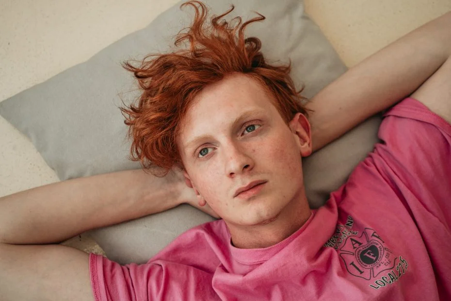 Red-haired man looking bored