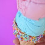 A colorful Ice cream cone in front of pink background